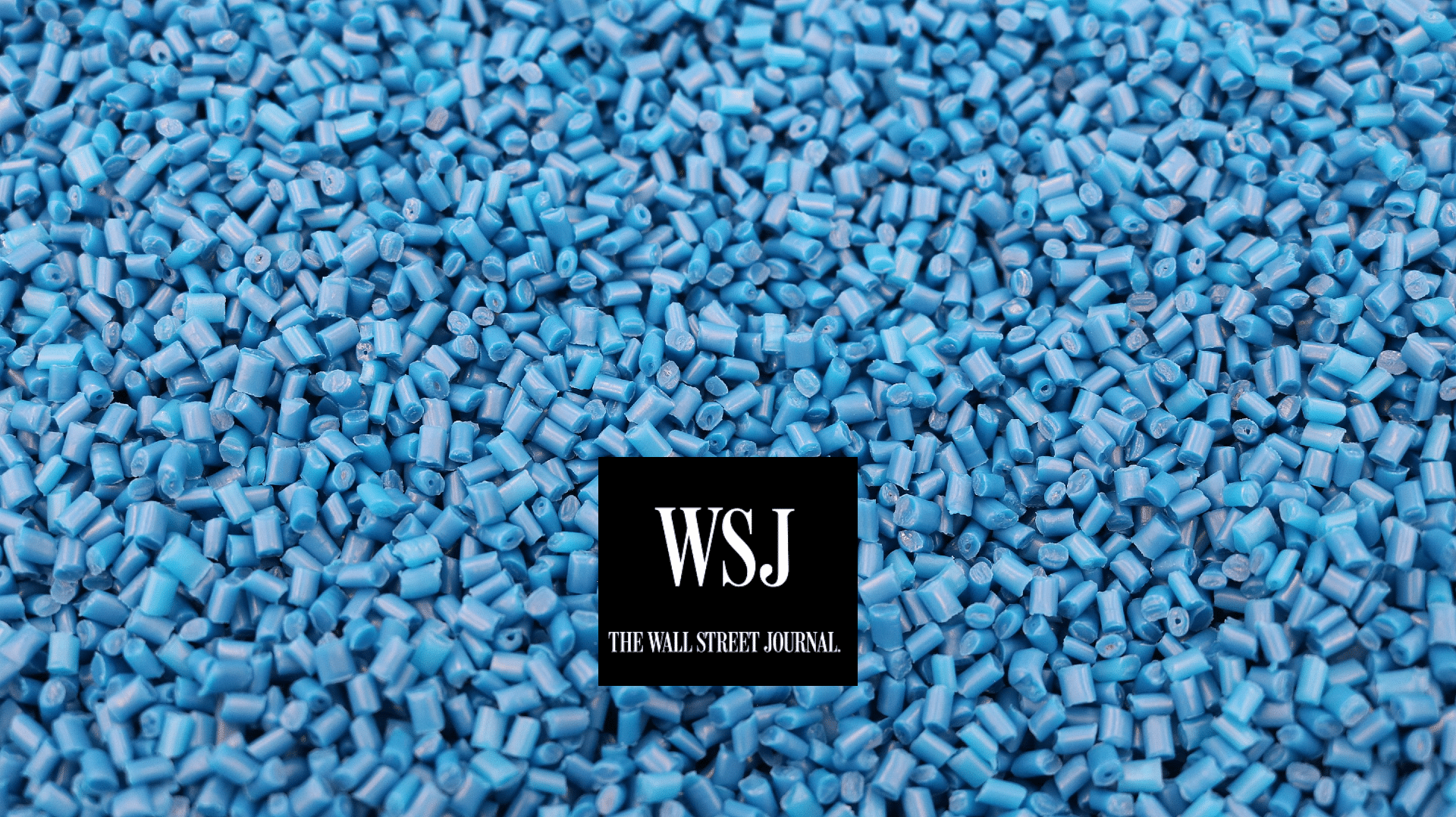 Blue plastic pellets with Wall Street Journal logo in foreground