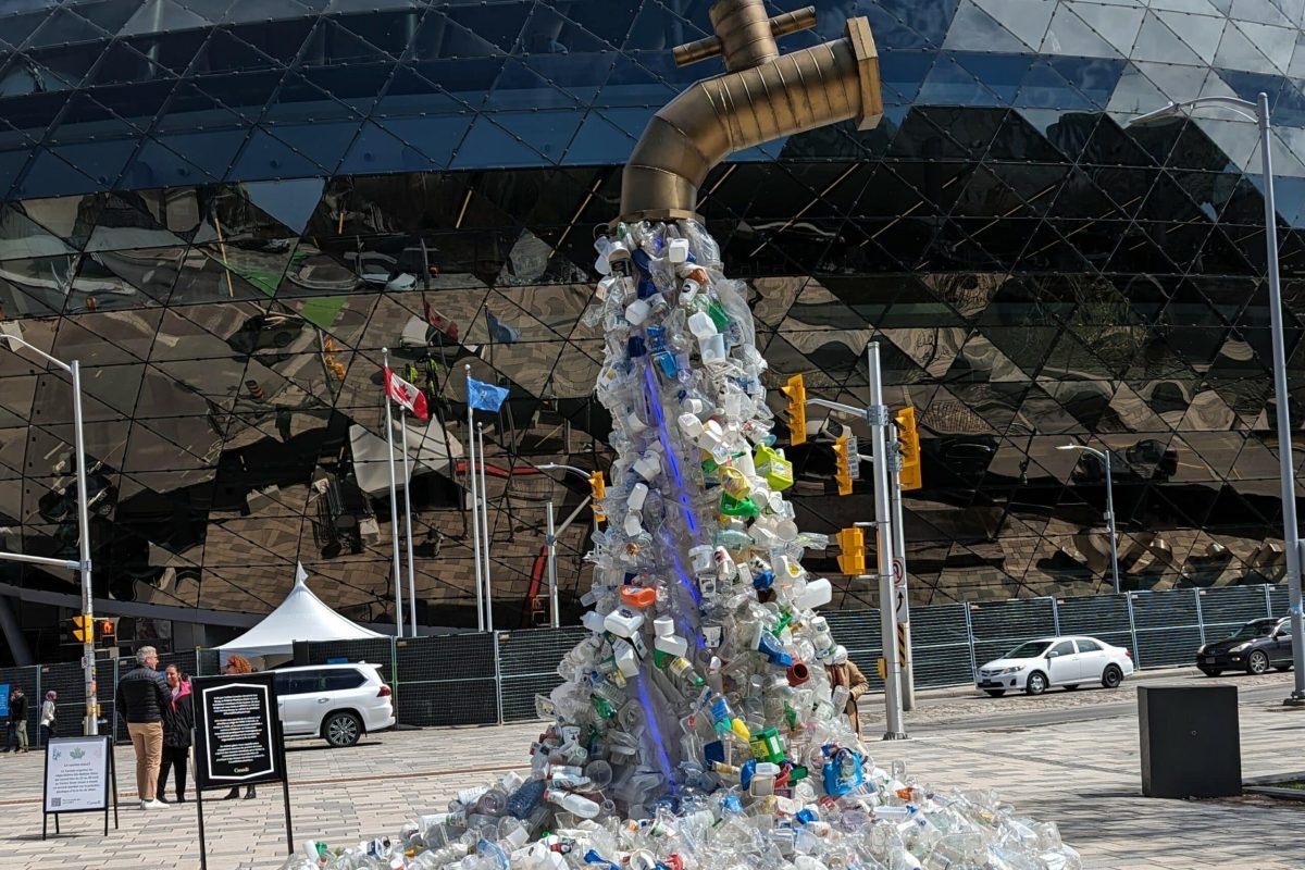 a large sculpture of a faucet spewing plastics